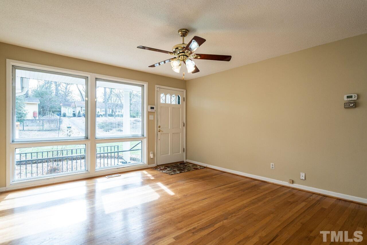 211 Quail Drive Raleigh, NC 27604 - Photo 6 of 28 wooden floor in an empty room with a window