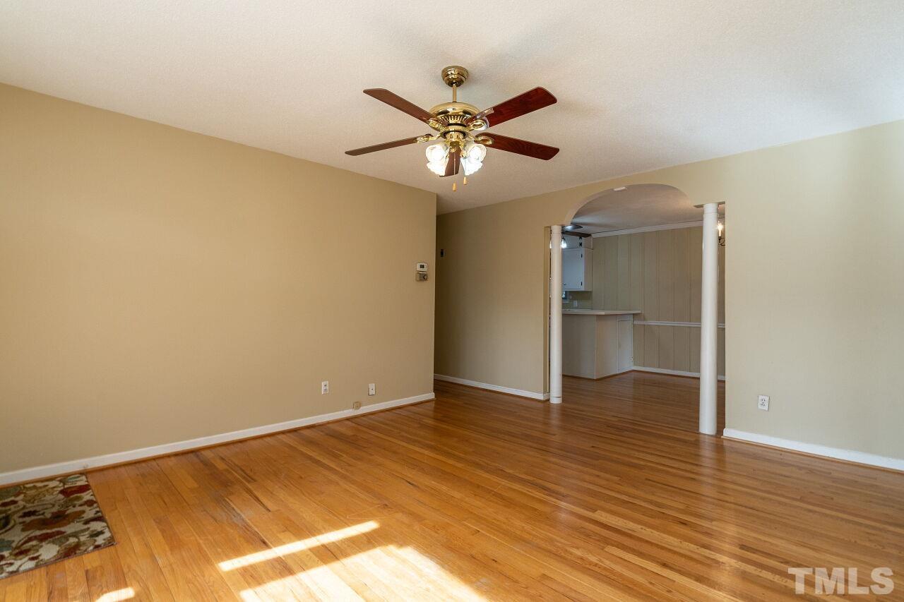 211 Quail Drive Raleigh, NC 27604 - Photo 7 of 28 a view of a livingroom with a ceiling fan and wooden floor