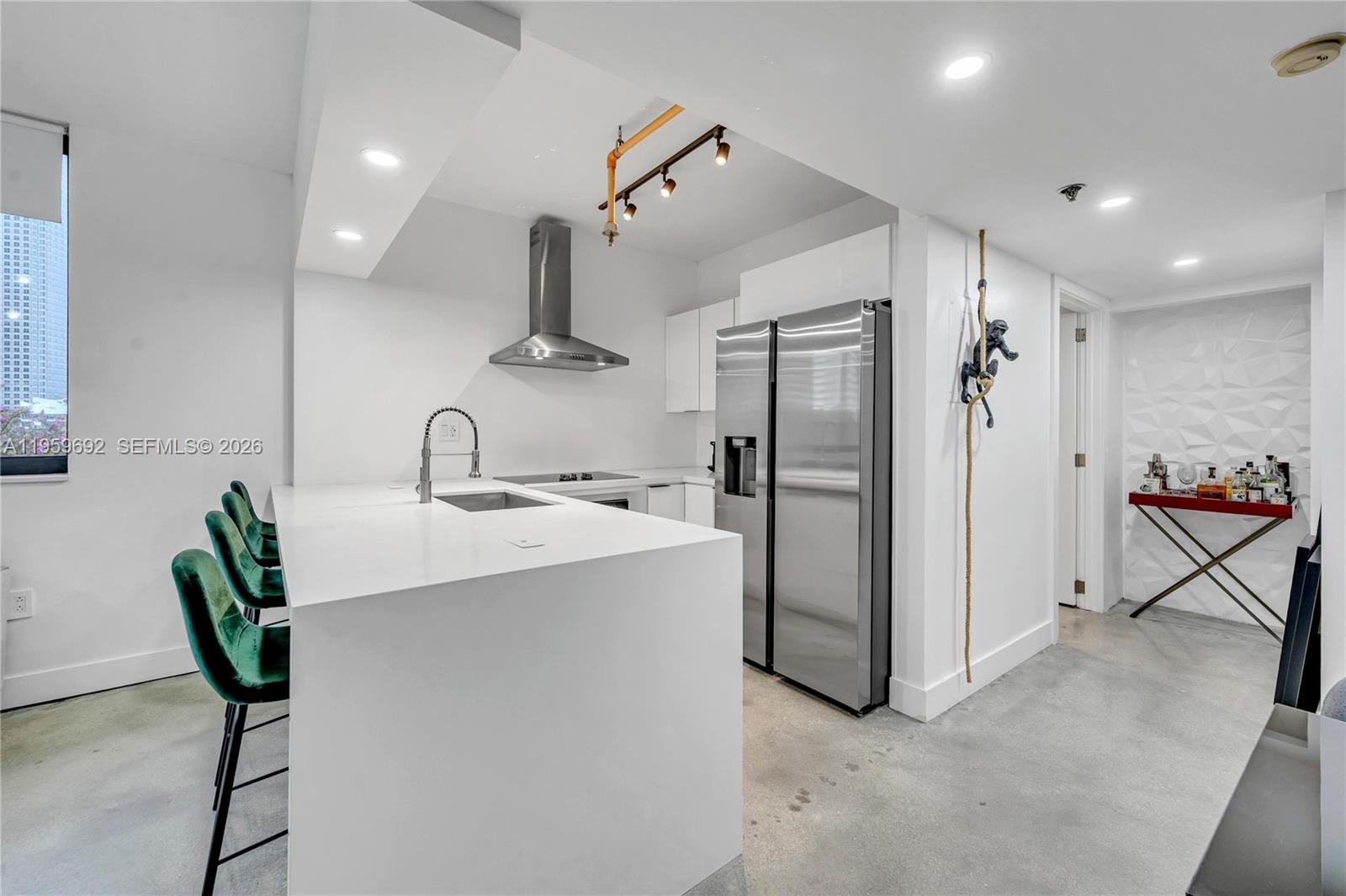 540 Brickell Key Drive, Unit 409 Miami, FL 33131 - Photo 12 of 20 a kitchen with refrigerator and chairs