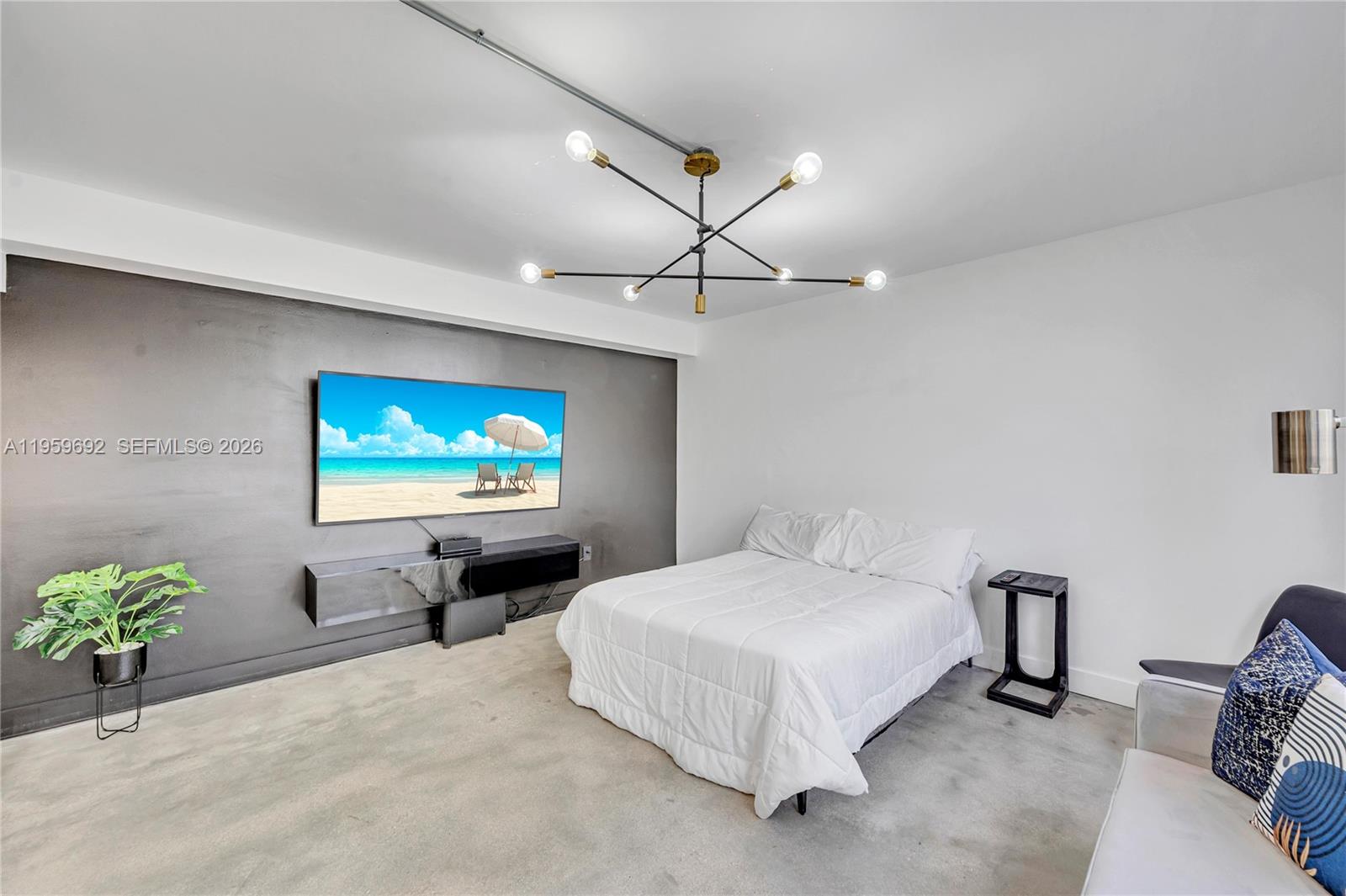 540 Brickell Key Drive, Unit 409 Miami, FL 33131 - Photo 8 of 20 a bedroom with a bed and a flat screen tv