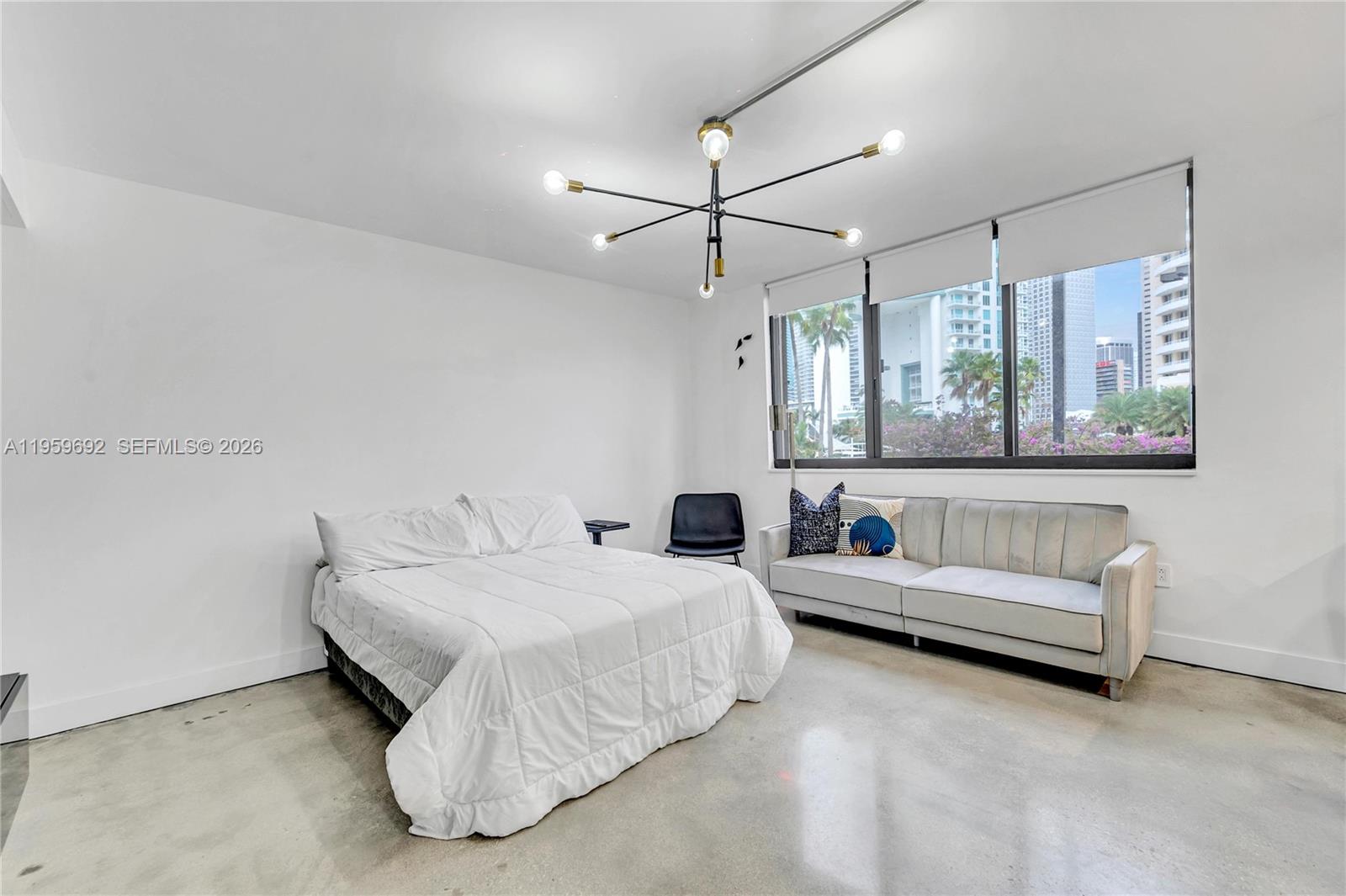 540 Brickell Key Drive, Unit 409 Miami, FL 33131 - Photo 9 of 20 a bedroom with a bed and a couch