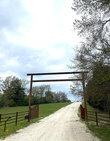 a view of a yard with wooden fence