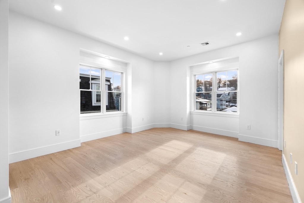 143 Tremont Street, Unit A Boston, MA 02135 - Photo 12 of 28 a view of an empty room with a window