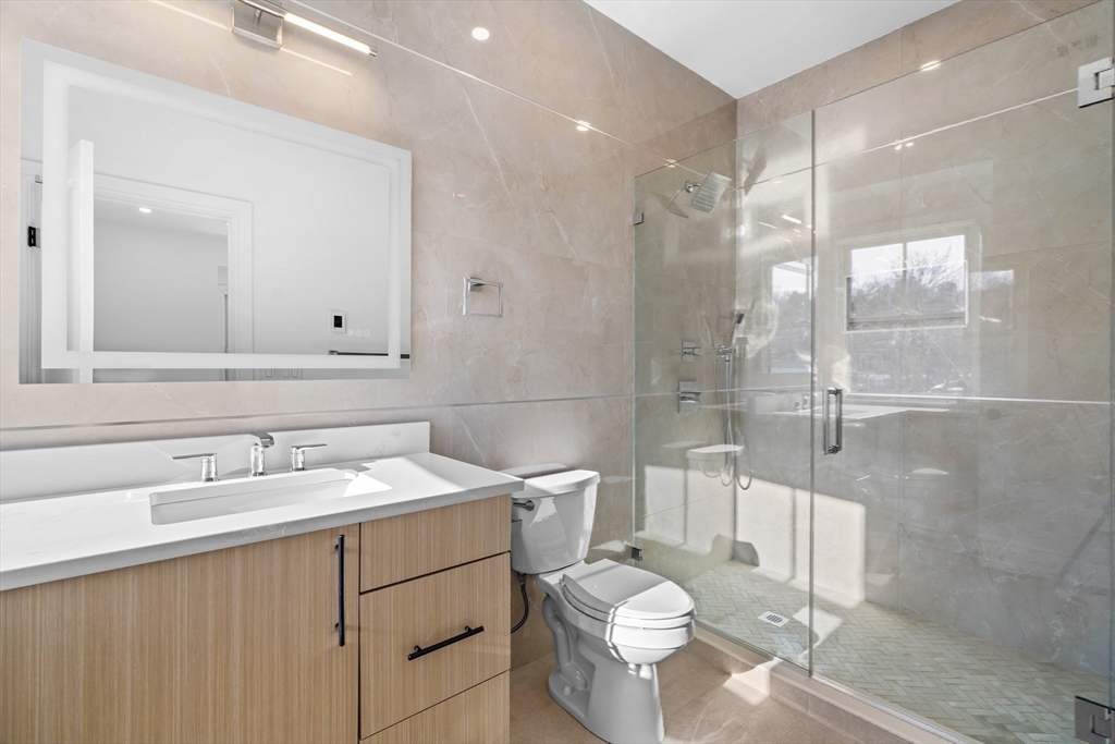 143 Tremont Street, Unit A Boston, MA 02135 - Photo 14 of 28 a bathroom with a sink toilet and shower