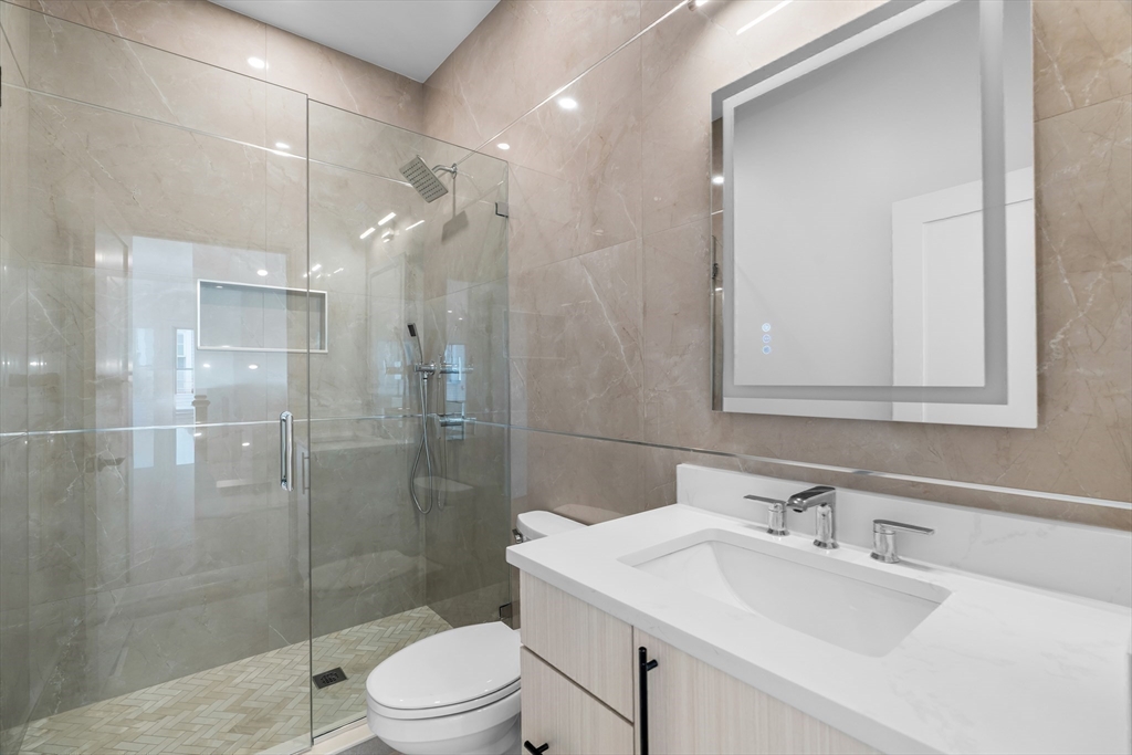 143 Tremont Street, Unit A Boston, MA 02135 - Photo 20 of 28 a bathroom with a sink toilet and shower