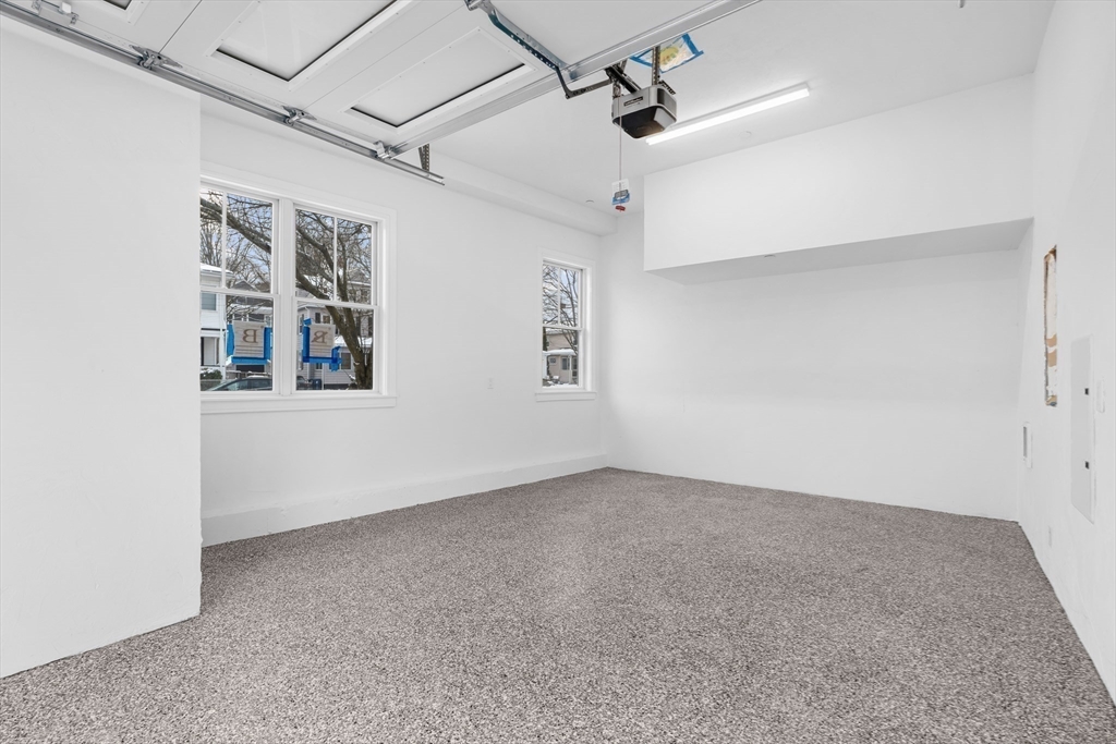 143 Tremont Street, Unit A Boston, MA 02135 - Photo 23 of 28 a view of an empty room with a window