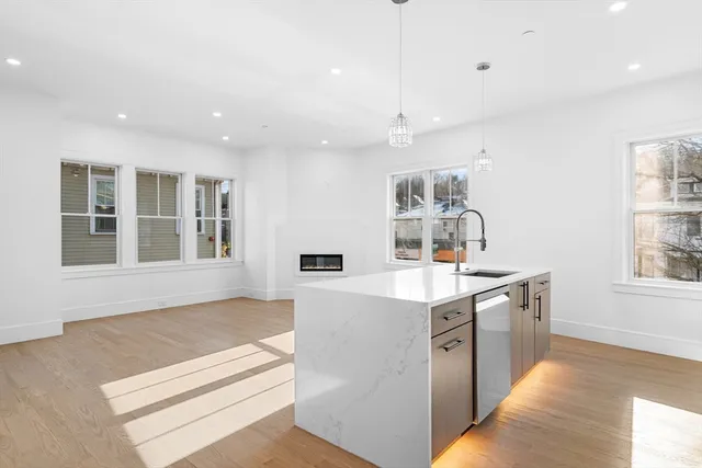a kitchen with a sink stove and cabinets