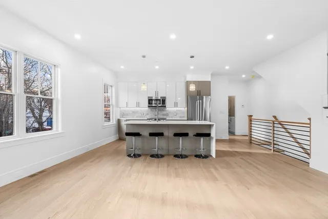 a large kitchen with a table and chairs in it