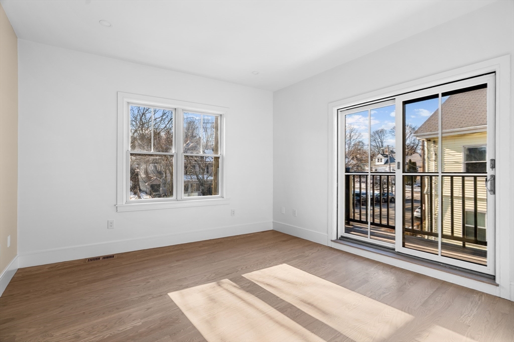 143 Tremont Street, Unit A Boston, MA 02135 - Photo 9 of 28 a view of an empty room with a window