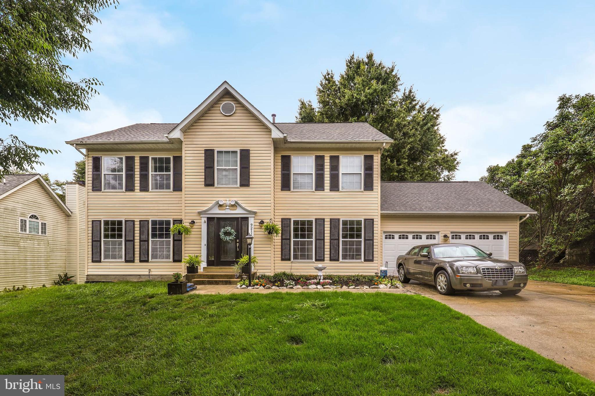 9211 Sandy Creek Road Fort Washington, MD 20744 - Photo 1 of 30 a front view of a house with a garden