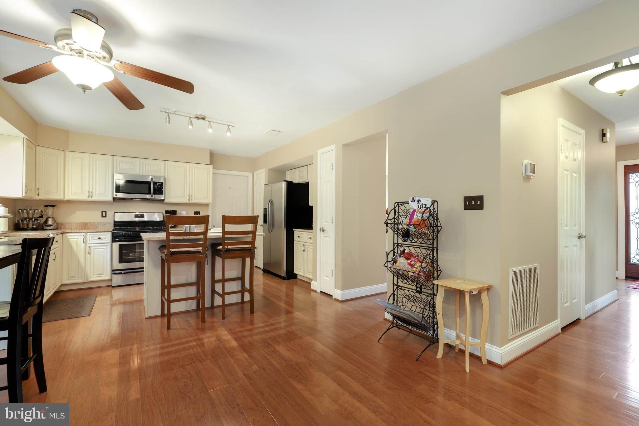 9211 Sandy Creek Road Fort Washington, MD 20744 - Photo 12 of 30 a view of a kitchen with furniture and wooden floor