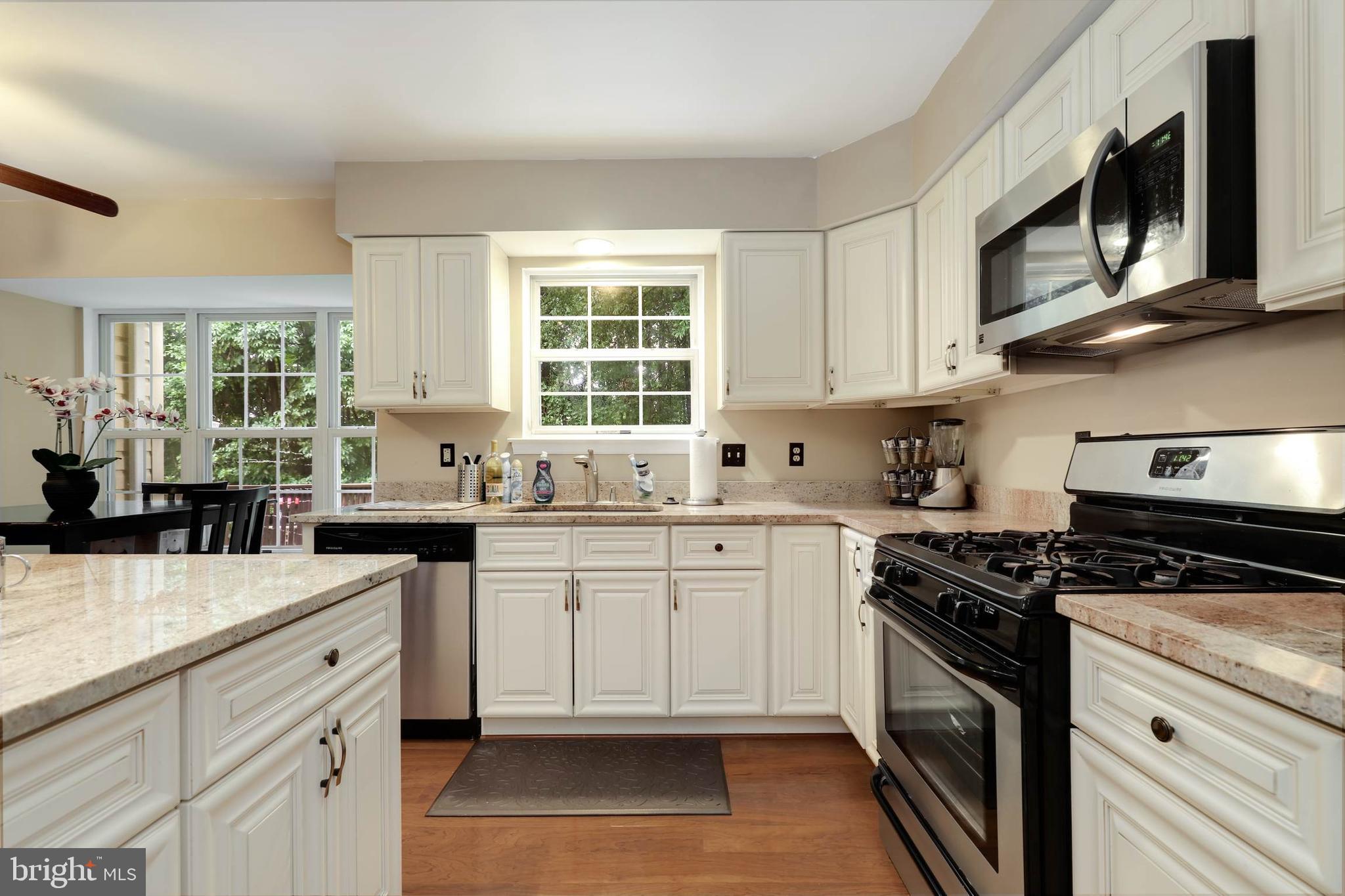 9211 Sandy Creek Road Fort Washington, MD 20744 - Photo 14 of 30 a kitchen with stainless steel appliances a white cabinets and a stove top oven