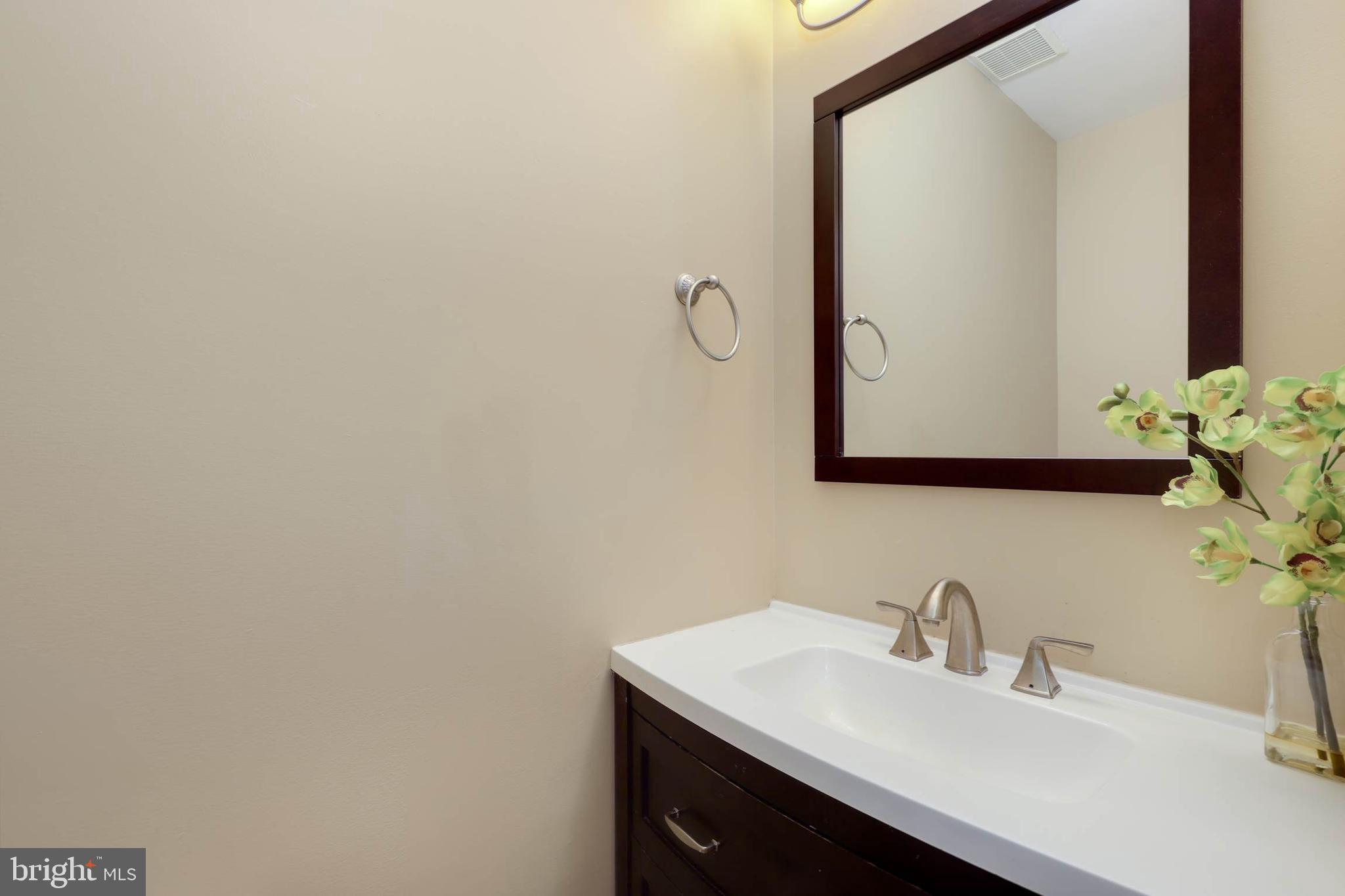 9211 Sandy Creek Road Fort Washington, MD 20744 - Photo 21 of 30 a bathroom with a sink and a mirror