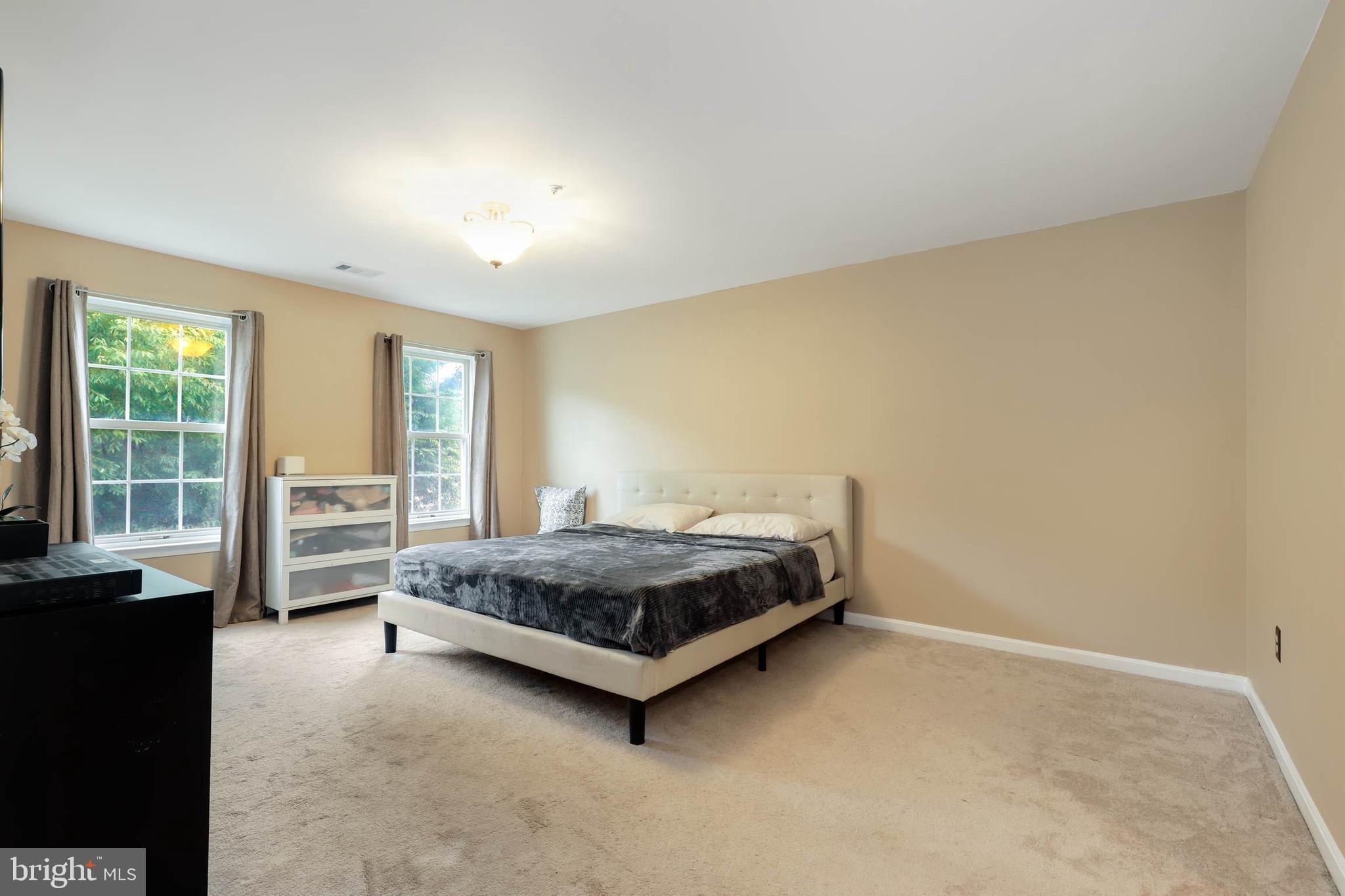 9211 Sandy Creek Road Fort Washington, MD 20744 - Photo 22 of 30 a spacious bedroom with a bed and a large window