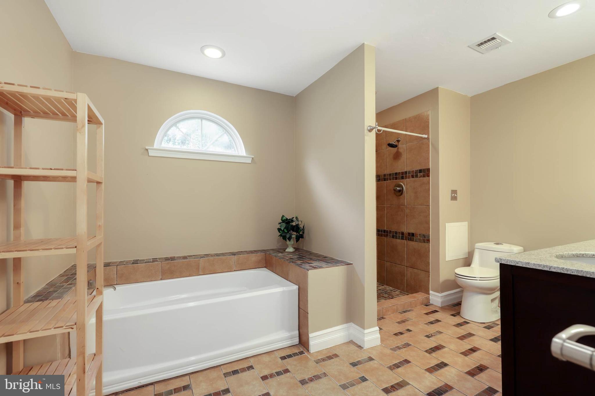 9211 Sandy Creek Road Fort Washington, MD 20744 - Photo 23 of 30 a bathroom with a sink a toilet and shower