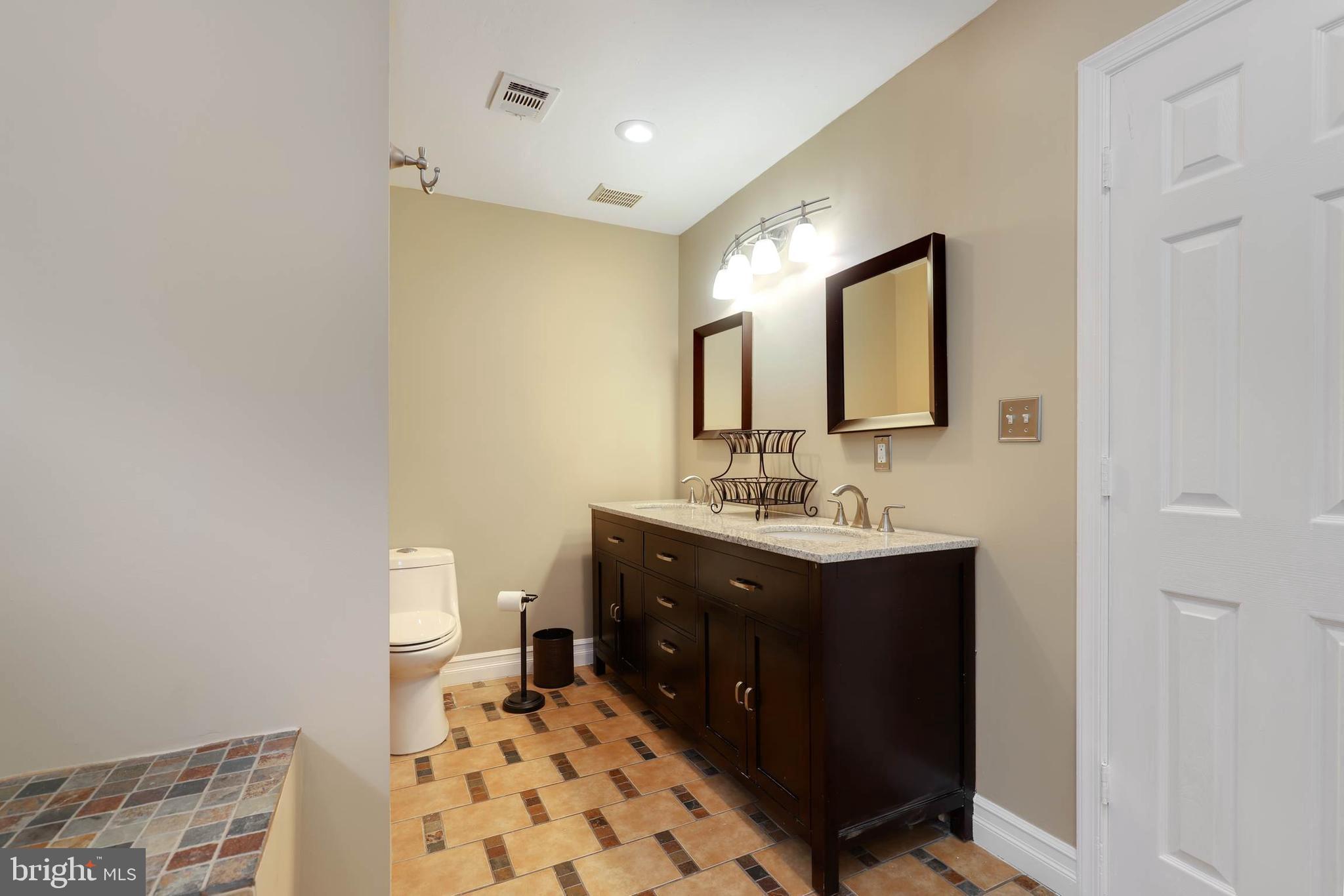 9211 Sandy Creek Road Fort Washington, MD 20744 - Photo 24 of 30 a bathroom with a sink vanity and mirror