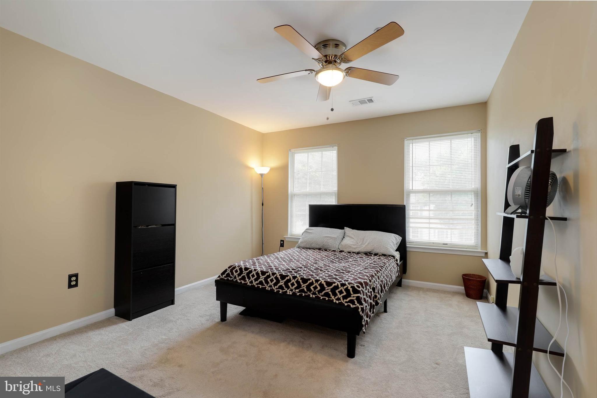 9211 Sandy Creek Road Fort Washington, MD 20744 - Photo 25 of 30 a bedroom with a bed and a chandelier