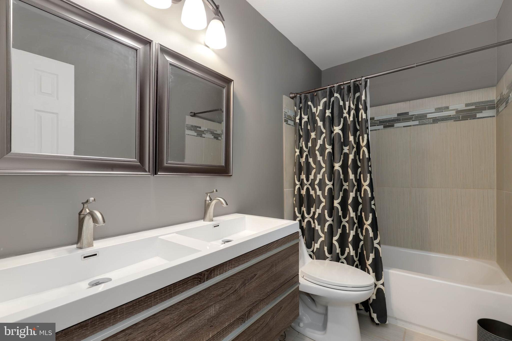 9211 Sandy Creek Road Fort Washington, MD 20744 - Photo 27 of 30 a bathroom with a sink toilet and shower