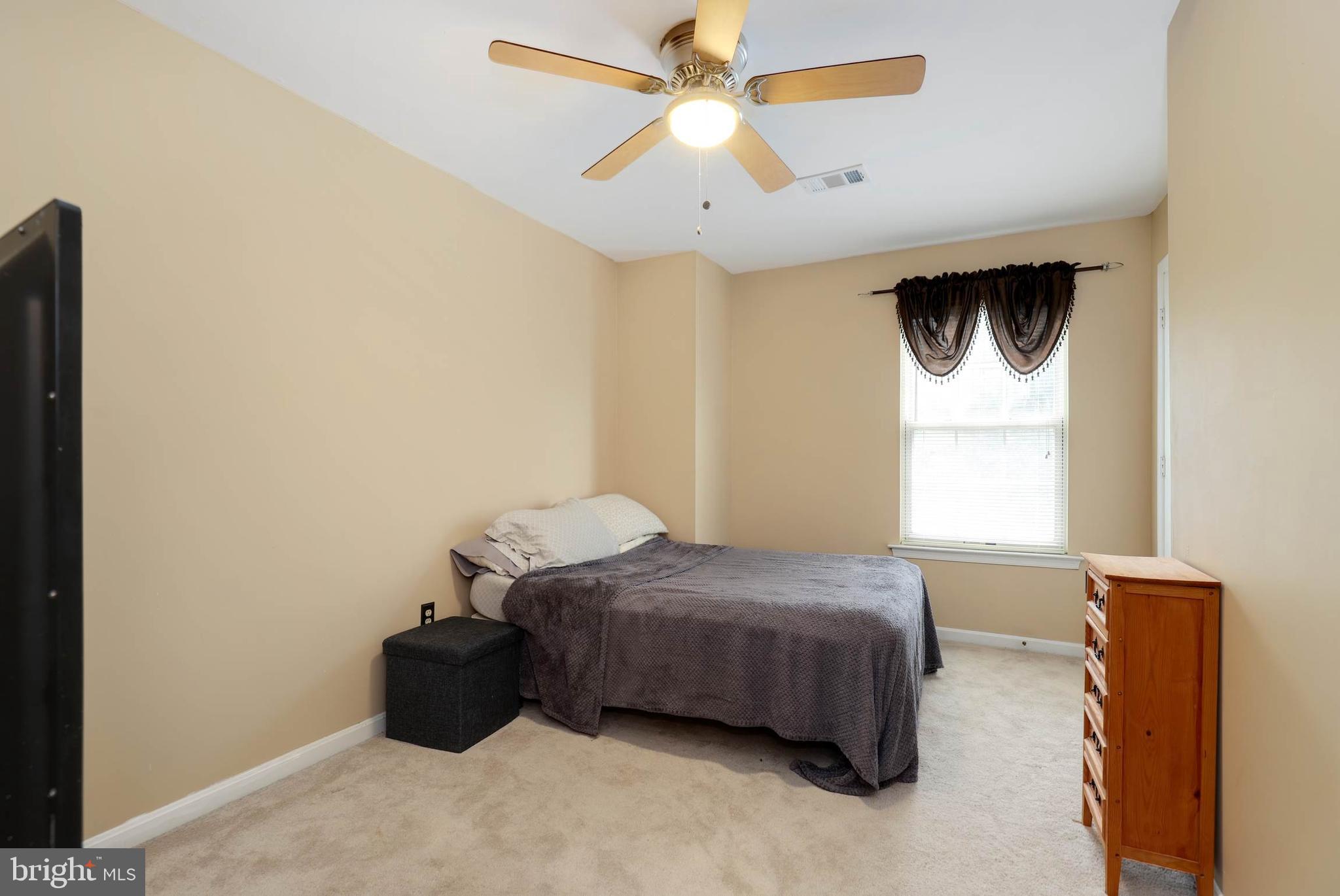 9211 Sandy Creek Road Fort Washington, MD 20744 - Photo 28 of 30 a bedroom with a bed and a window