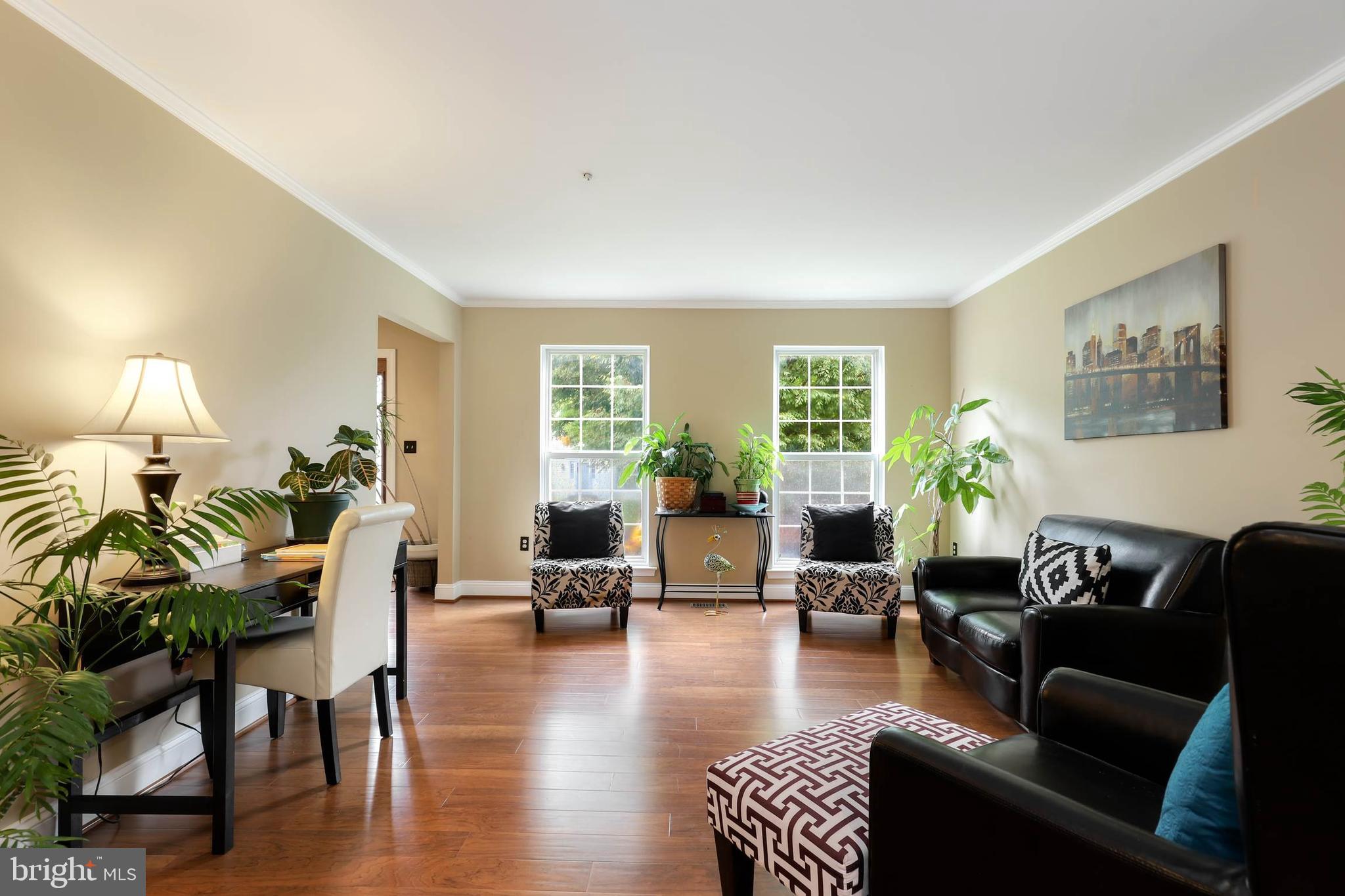 9211 Sandy Creek Road Fort Washington, MD 20744 - Photo 5 of 30 a living room with furniture floor to ceiling window and wooden floor