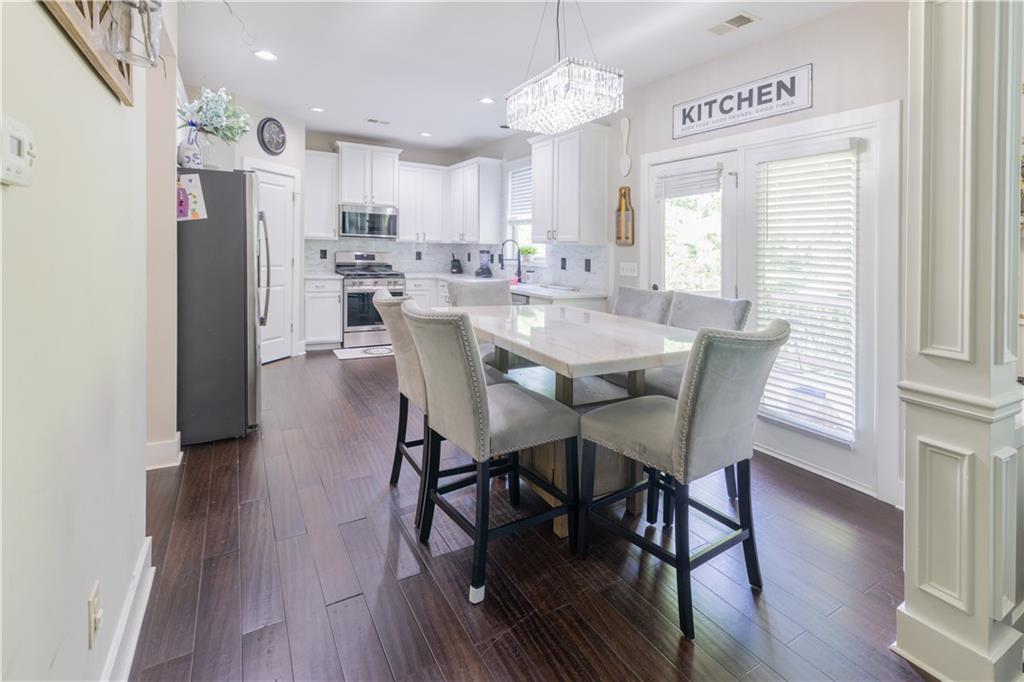 1567 Maplecliff Way Sugar Hill, GA 30518 - Photo 14 of 31 a view of a dining room with furniture window and wooden floor