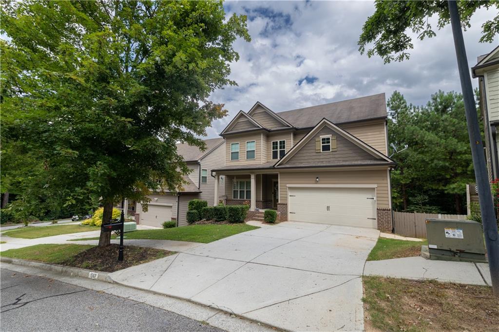 1567 Maplecliff Way Sugar Hill, GA 30518 - Photo 2 of 31 a front view of a house with a yard