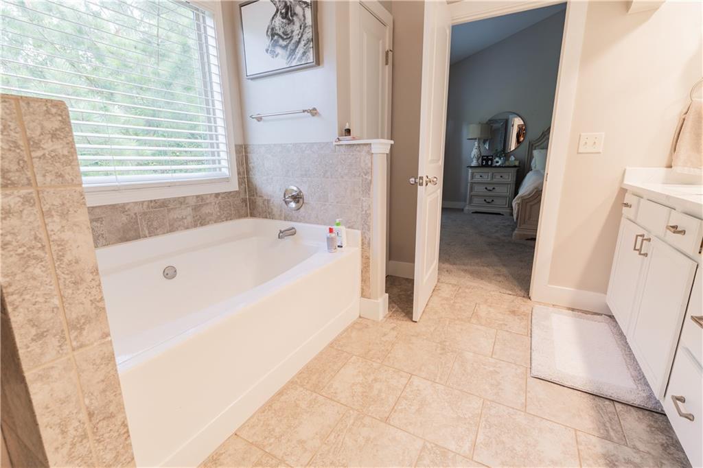 1567 Maplecliff Way Sugar Hill, GA 30518 - Photo 22 of 31 a bathroom with a bathtub and a sink