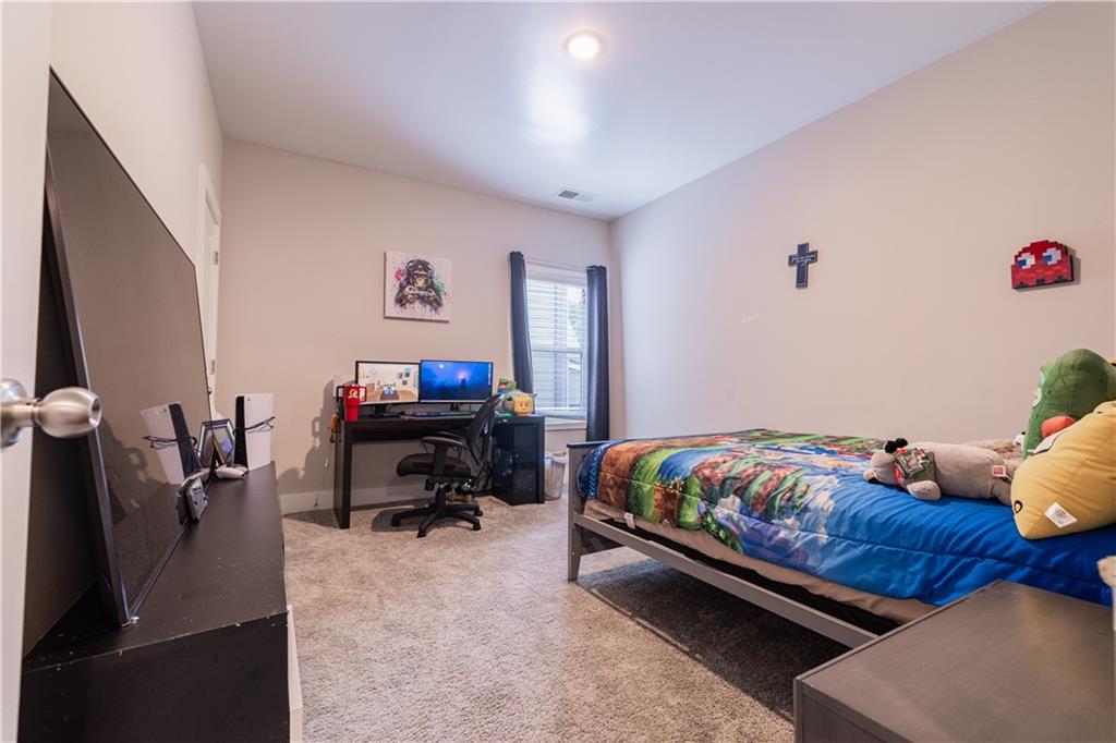 1567 Maplecliff Way Sugar Hill, GA 30518 - Photo 25 of 31 a bedroom with a bed and a couch