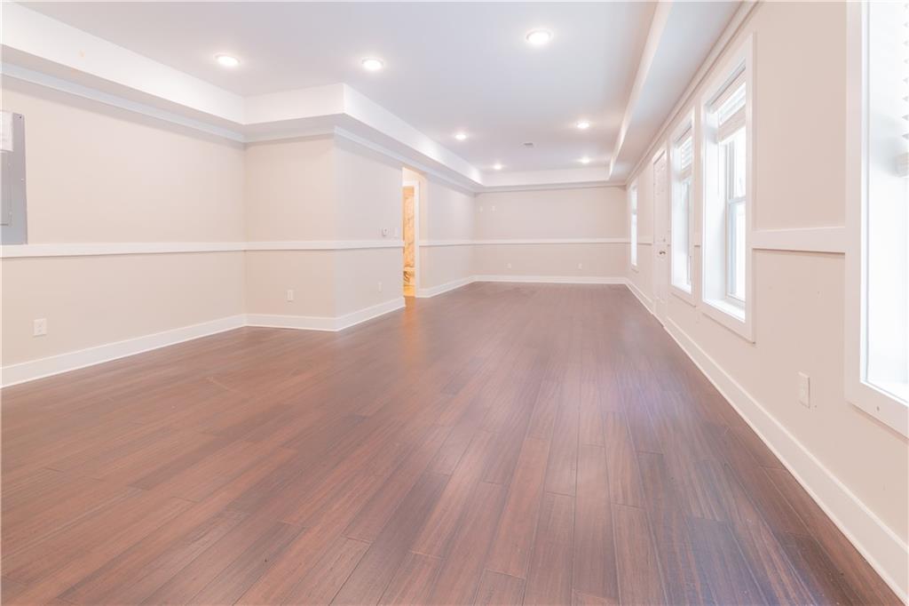 1567 Maplecliff Way Sugar Hill, GA 30518 - Photo 26 of 31 a view of an empty room with wooden floor