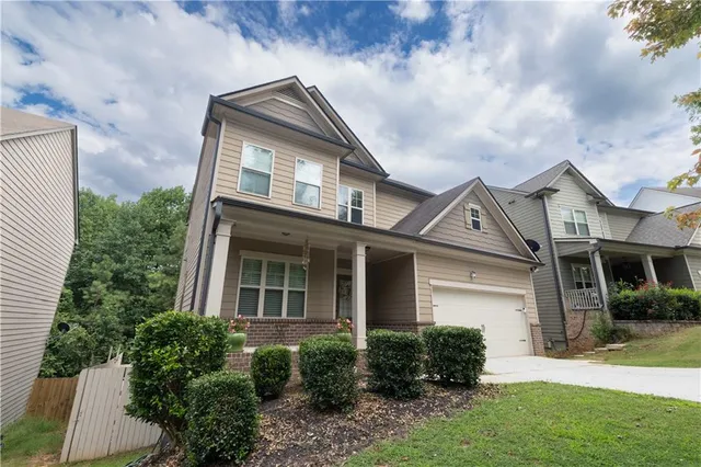 a front view of a house with a yard