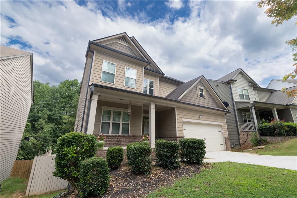 1567 Maplecliff Way Sugar Hill, GA 30518 - Photo 5 of 31 a front view of a house with a yard