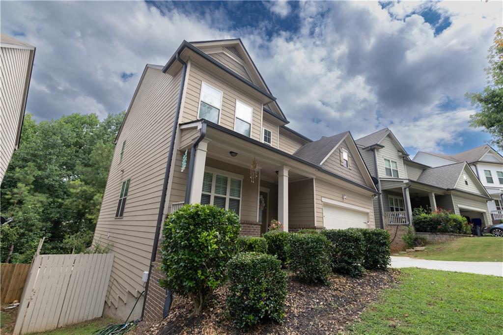 1567 Maplecliff Way Sugar Hill, GA 30518 - Photo 6 of 31 a view of a white house next to a yard