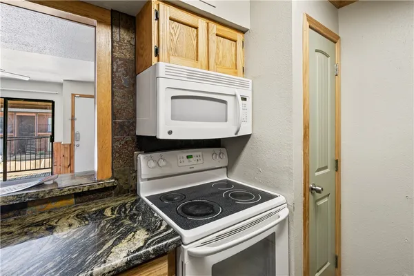 a living room with a stove and a window