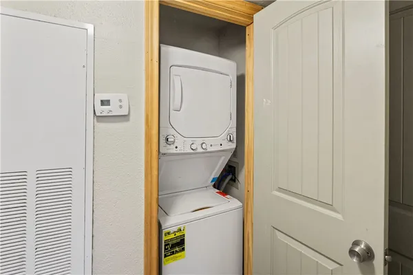 a view of a porch with a door and wooden floor