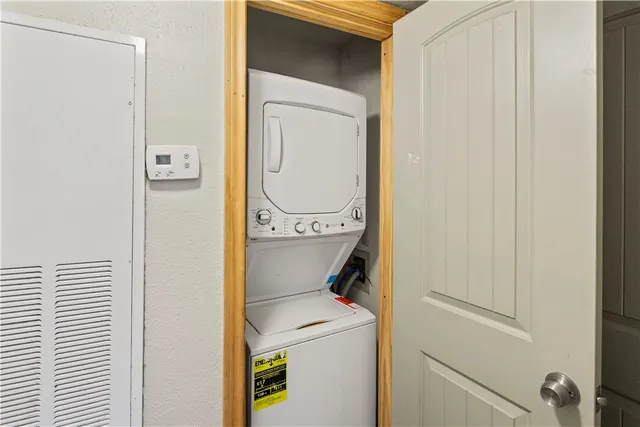 a view of a porch with a door and wooden floor