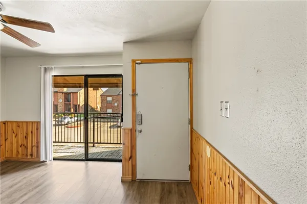 a view of a hallway with wooden floor and a window