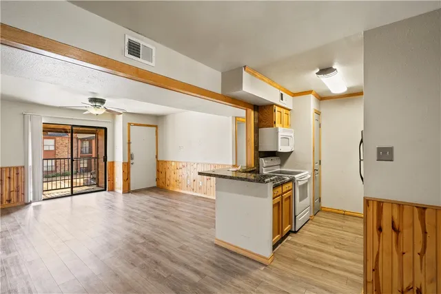 a kitchen with stainless steel appliances granite countertop a stove and a refrigerator