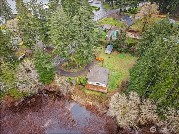 an aerial view of a house with a garden and swimming pool