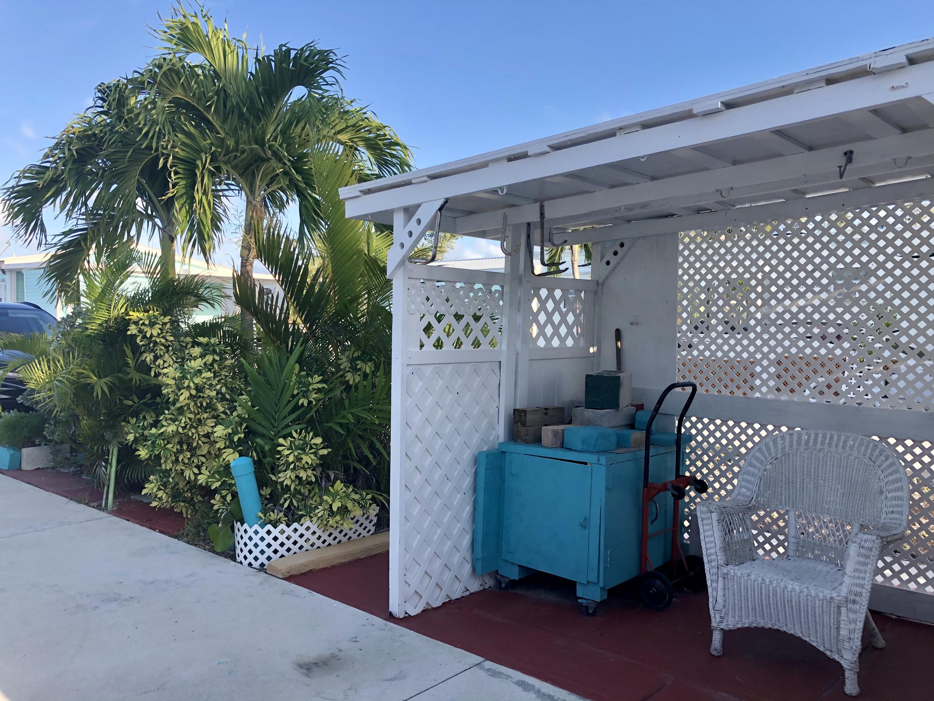 55 Boca Chica Road, Unit 461 Key West, FL 33040 - Photo 23 of 37 a view of a porch with chairs and potted plants