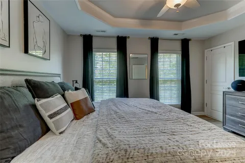 a bedroom with bed and large window