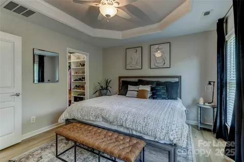 a bedroom with a bed and a chandelier