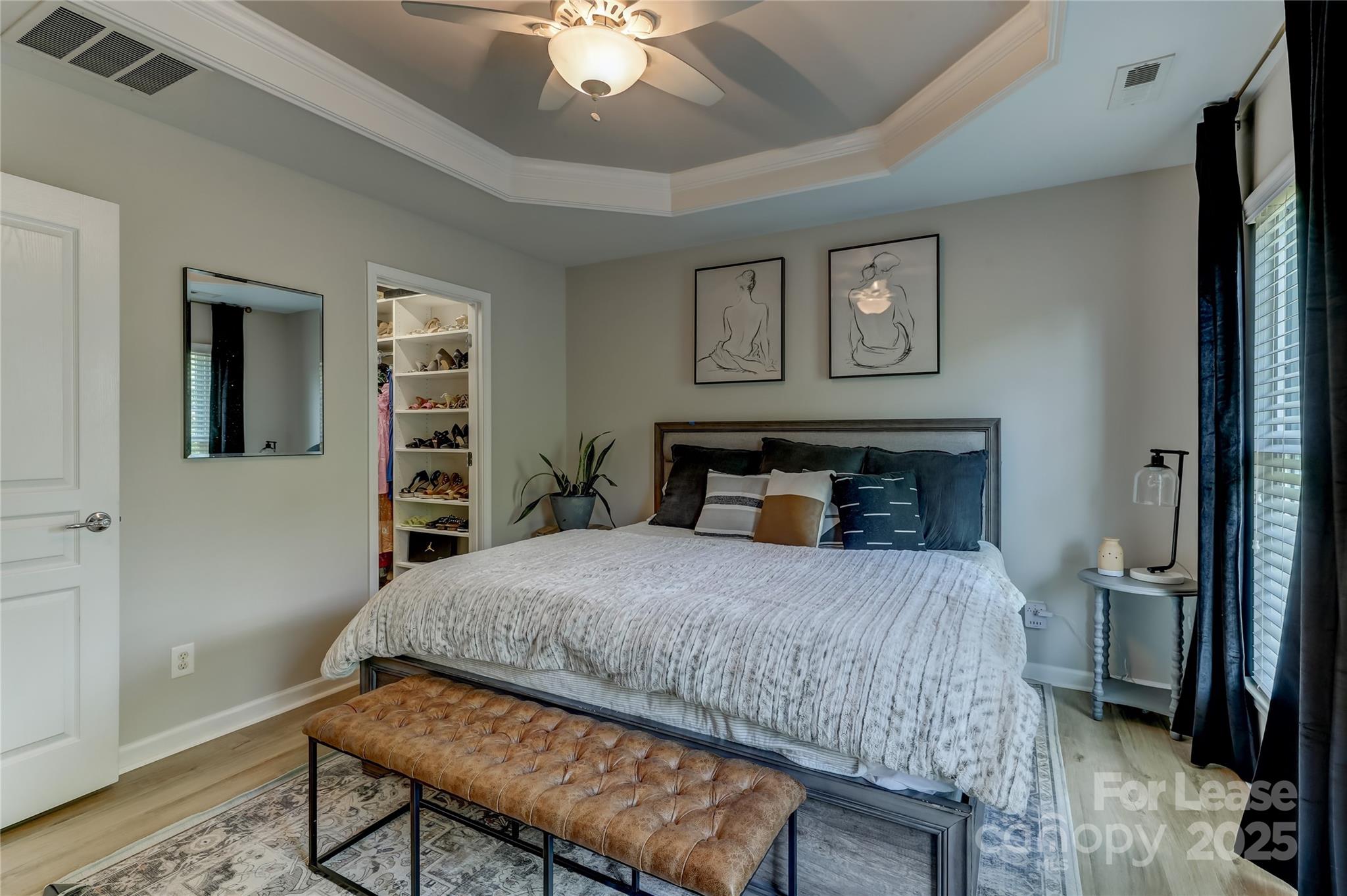 1132 Drayton Court Fort Mill, SC 29708 - Photo 24 of 41 a bedroom with a bed and a chandelier