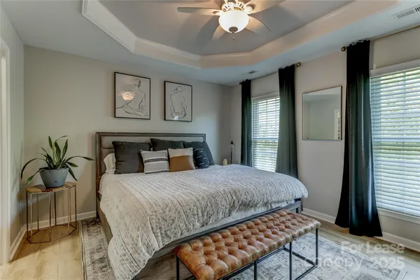 a bedroom with a bed and a chandelier