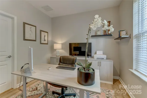 a view of a workspace with furniture and chandelier