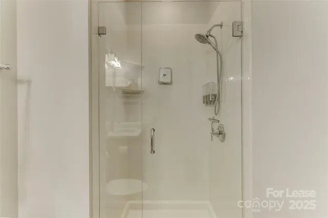 a bathroom with a glass shower door