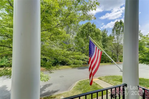 a view of a park with plants and wooden fence
