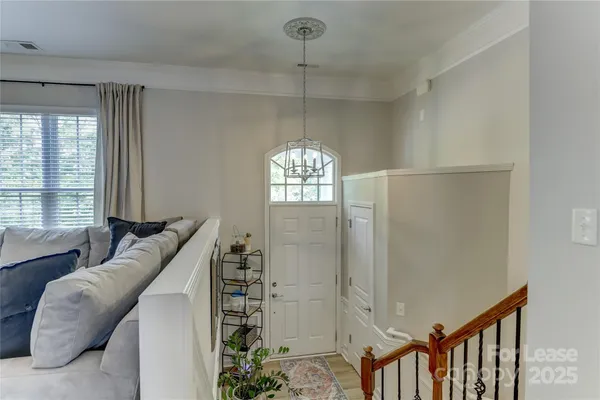 a living room with furniture and a chandelier