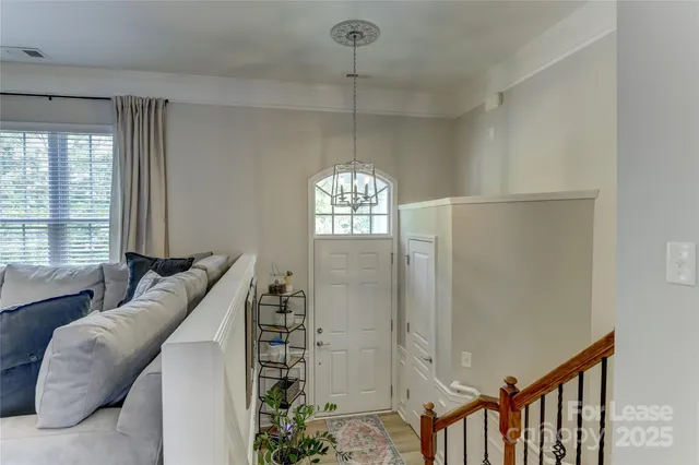 a living room with furniture and a chandelier