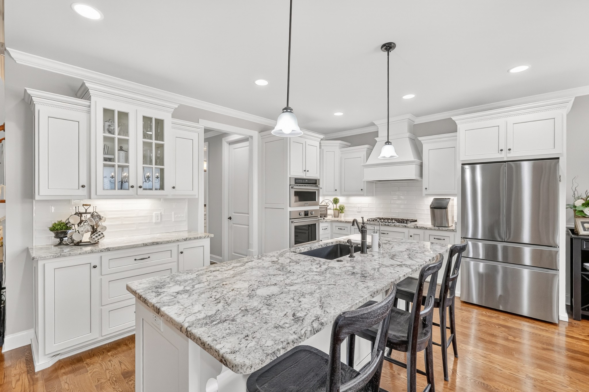 2007 Imagine Circle Spring Hill, TN 37174 - Photo 17 of 44 a kitchen with granite countertop a table chairs stainless steel appliances and wooden floor