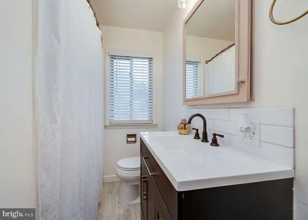 a bedroom with a bed a flat screen tv and a chandelier